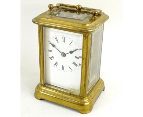 A 19th century French brass carriage clock, with four bevelled glass panes, the white enamel face with black Roman numerals, 