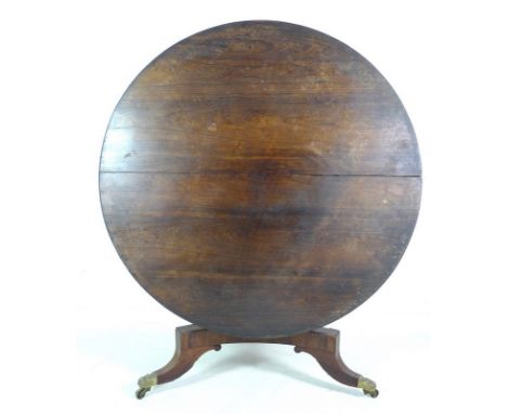 A Victorian rosewood and mahogany veneered breakfast table, circular tilt top surface with beaded edge, concave triangular se