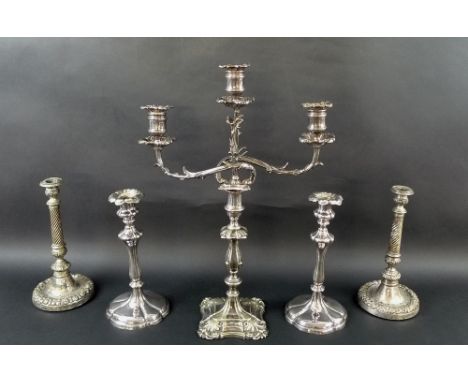 An early 20th century silver plated three branch candelabra with cast leaf arms and curving lobes, armorial engraved to stepp