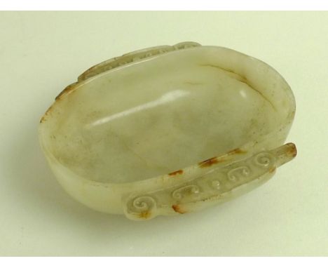 A Chinese mutton fat jade dish, Qing Dynasty, 18th / 19th century, of rounded oblong form with two handles carved with opposi