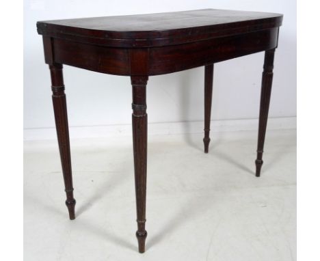 A Regency mahogany card table, D form fold over surface with ebony stringing, revealing a pink baize, kick leg action, raised