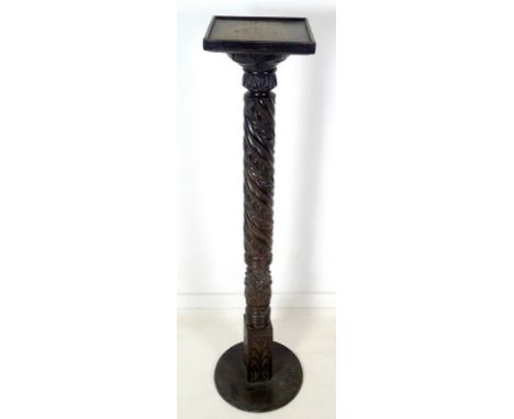 An early 20th century ebonised wood jardiniere stand, with spiral carved column, square surface and circular base, 36 by 136c