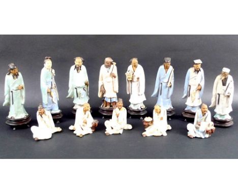 A collection of thirteen Chinese 'mud man' pottery figurines, early 20th century, eight modelled in various standing poses an