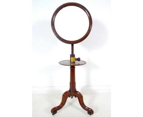 An early Victorian mahogany shaving stand, circular plate in moulded frame supported on a ratchet adjustable column with lobe