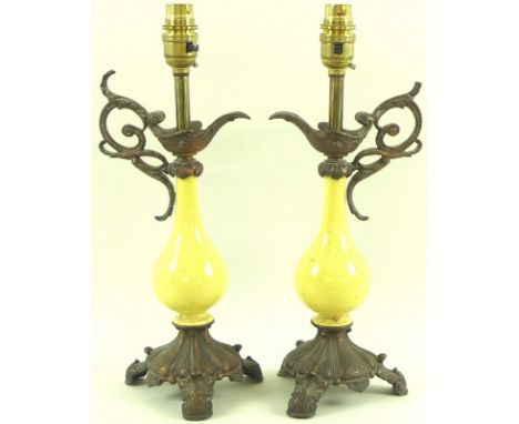 A pair of table lamp bases, 20th century, comprising bottle vases decorated in yellow glaze, mounted with metal urn handles a