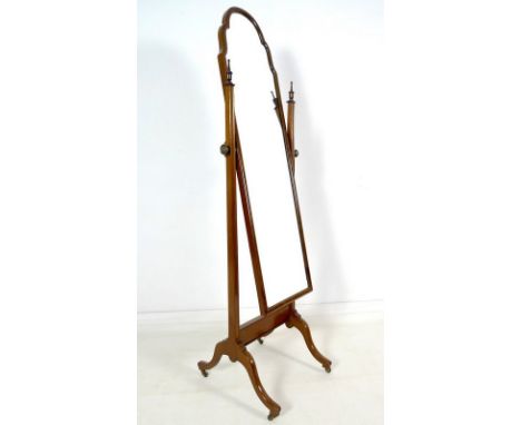 An Edwardian mahogany cheval dressing mirror, rectangular plate with break arch top in a cushion moulded frame, channeled sup