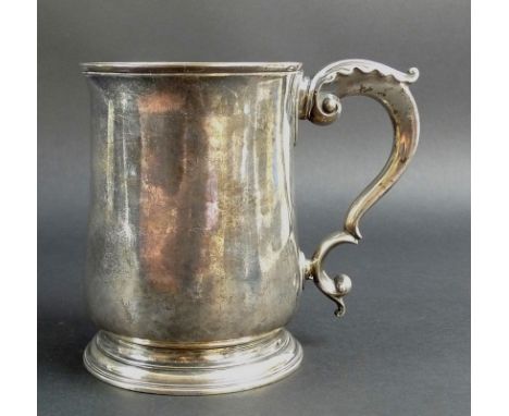 An early George III silver tankard, of tapering plain cylindrical form, with scrolling acanthus handle and ribbed foot, Willi