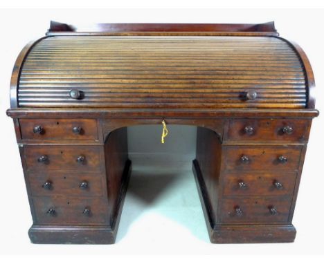 An early Victorian mahogany twin pedestal desk, by Holland & Sons, tambour roll top enclosing a fitted interior and large gil