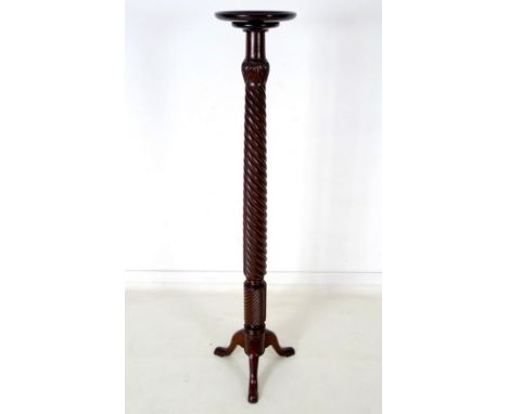 An early to mid 20th century mahogany torchere, with barley twist stem and tripod base, 40 by 152cm high.
