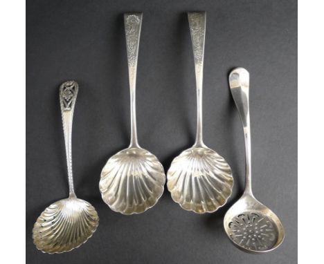 A pair of George III Irish silver sauce ladles, with shell shaped bowls and engraved floral decoration to the handles, turned
