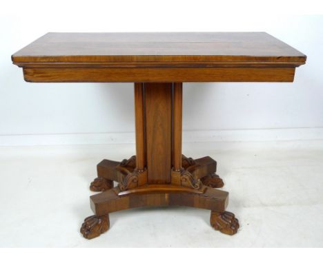 A Victorian rosewood card table, with crossbanded decoration to the fold over surface, inset with baize, raised on a square s