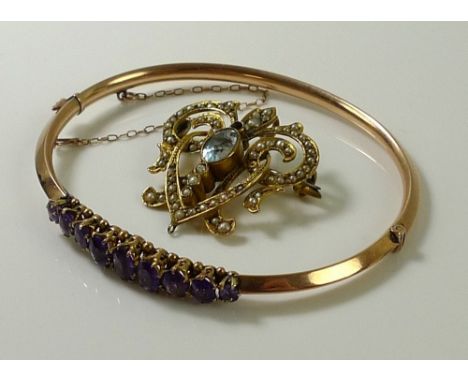 A Victorian rose gold bangle set with nine oval cut amethysts, largest stone 6.3 by 3.5mm, one stone a/f damaged, safety chai