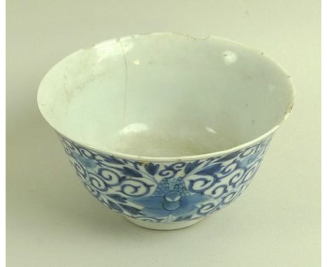 A Chinese porcelain tea bowl, Qing Dynasty, mid 18th century, decorated in underglaze blue with four orchids in a scrolling g