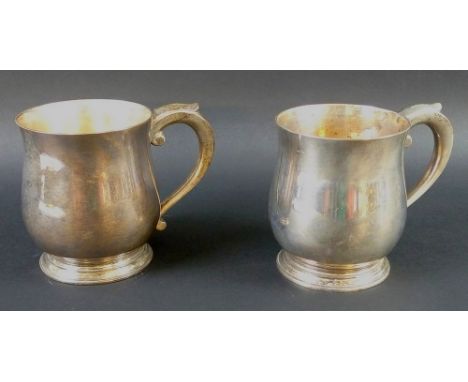 A pair of George VI silver tankards, of rounded bellied form with ribbed feet, C-scrolls handles, Goldsmiths & Silversmiths C