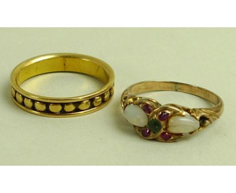 An 18ct gold ring, of beaded design within border, cast as a row of bead forms set within a band, maker 'BG', size O, 3.6g, t