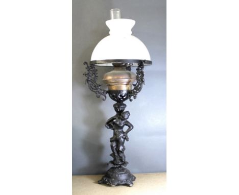 A Victorian oil lamp with opal vesta glass shade mounted onto a  modern black metal base of Art Nouveau style, depicting a se