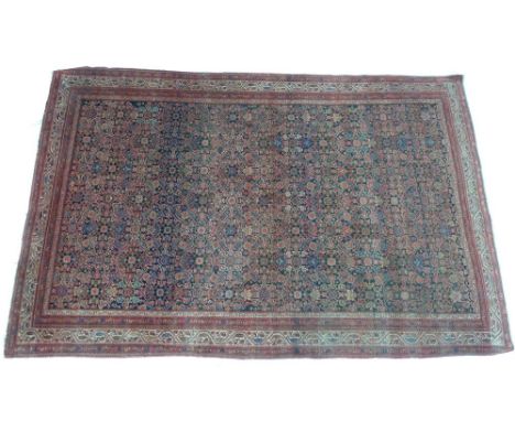 A fine antique Persian Senna rug, with dark blue/black ground, decorated to the field with an all over repeating close patter