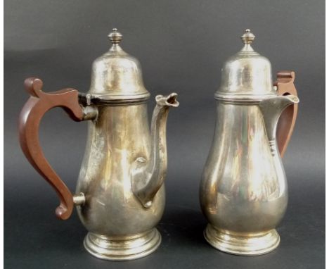 A George V silver chocolate pot with matching hot water pot, both of bellied form with compressed globular knops and ribbed d