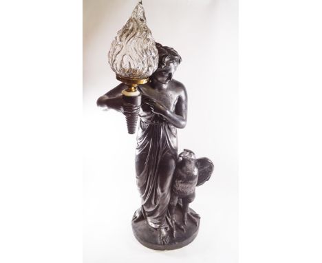 A large plaster electrified lamp, modelled as a robed maiden holding aloft a torch, the shade being the flame, with an eagle 