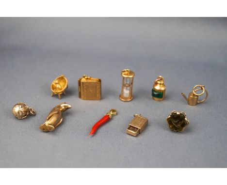 An assortment of ten yellow gold charms to include a Seal fob, Holy bible (with paper), Globe, Chilli, Match box, Cats cradle