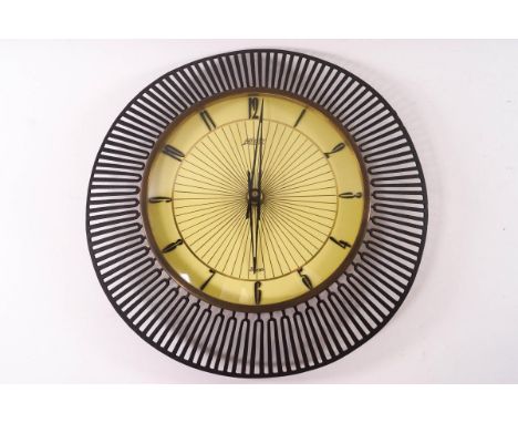 A mid-20th century Atlantic electric wall clock with pierced metal surround, 32cm diameter