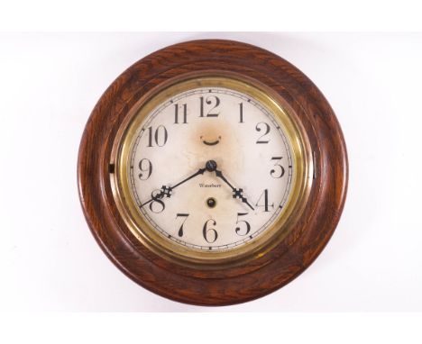 An American oak framed round wall clock, the dial marked Waterbury, 31cm diameter