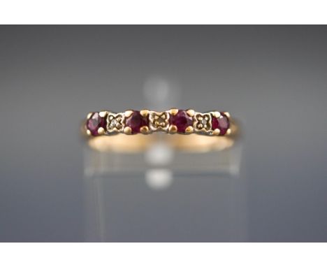 A yellow gold ring set with four rubies and five diamonds. Hallmarked 9ct gold, London. Size: M. 1.4 grams