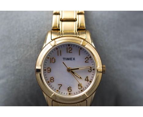 A lady's wristwatch by Timex, gold plated case and bracelet with a round mother of pearl dial having numerical markings. Boxe
