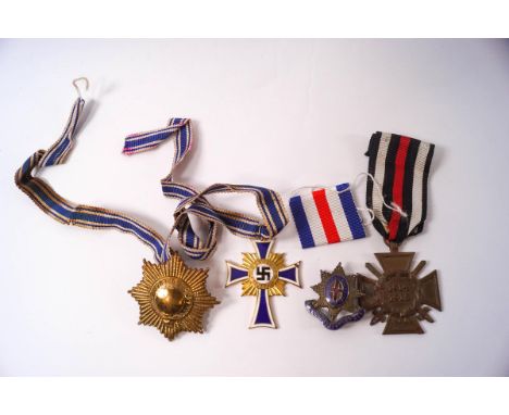 A German enamel and gilt metal Mothers cross, a WWI German cross, an Old Coldstreamer Association badge and a further badge