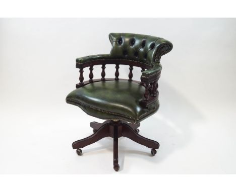 A 20th century green leather swivel Captain's chair with button back, 63cm wide