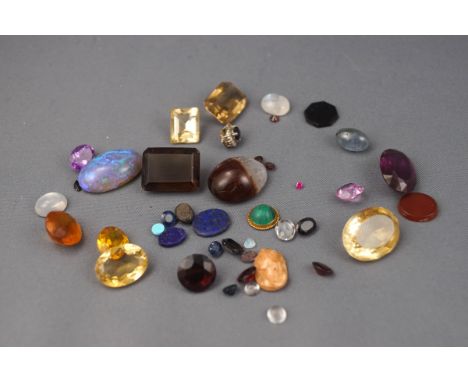 A collection of loose gem stones to include various quartz, one opal, agate, cameo and some paste stones.
