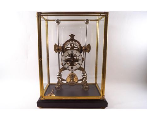 A skeleton clock with eight day fusee movement and grasshopper escape, cased and on a stand, 44cm high x 34cm wide x 24cm dee
