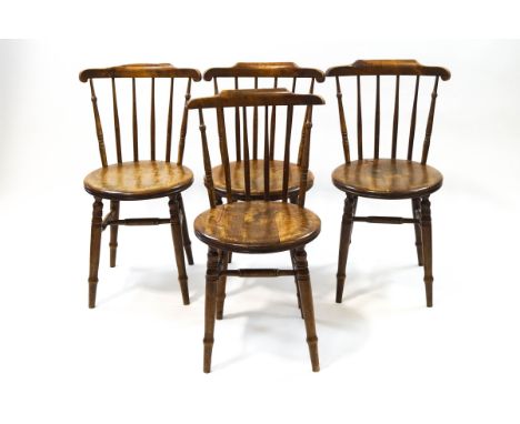 A set of four Victorian beech stick back dining chairs on turned tapering legs with H-stretchers