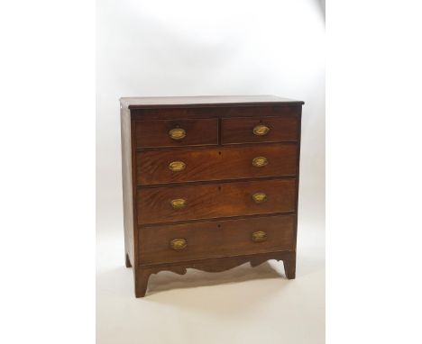 A George III mahogany chest of two short over three long drawers with oval brass handles, shaped skirt and bracket feet, 120c