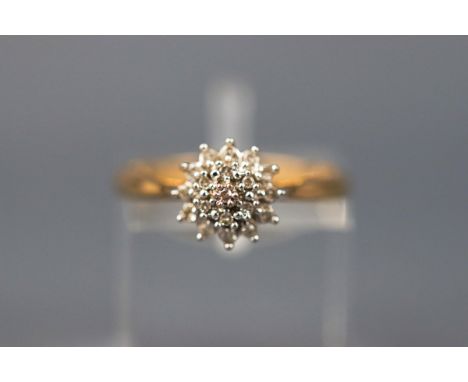 A yellow gold cluster ring set with nineteen single cut diamonds. Yellow gold shank. Hallmarked 9ct gold, London. Stamped DTA