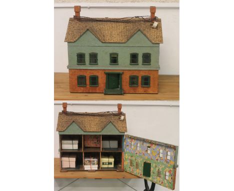 A vintage rough cast 2 storey dolls house, complete with dolls house furniture 