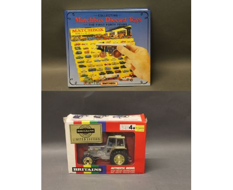 A Matchbox die cast toys "Collecting The First 40 Years" book, together with a boxed Britain's limited edition tractor (5892)