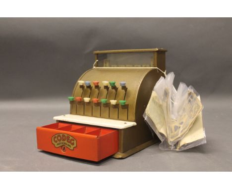 A vintage child's Codeg cash register with fake money 