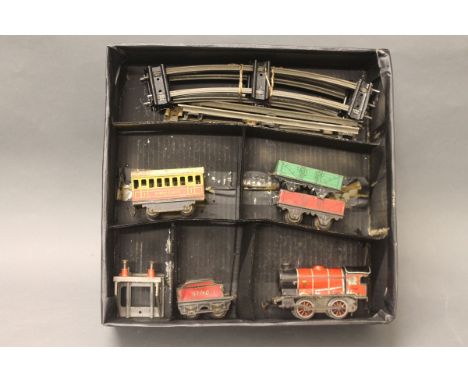 A boxed Hornby O gauge clockwork train set comprising locomotive, first class coach, wagons, buffer stop and track