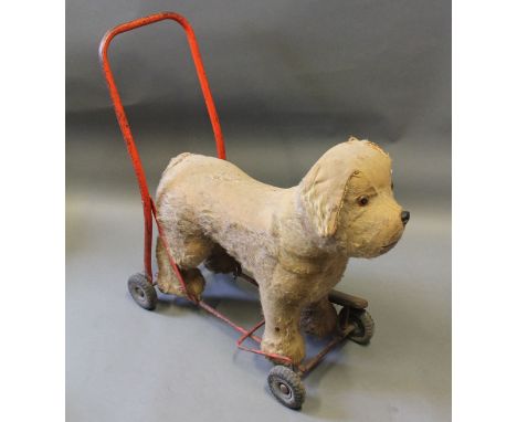 A vintage Lines Bros stuffed dog on wheels