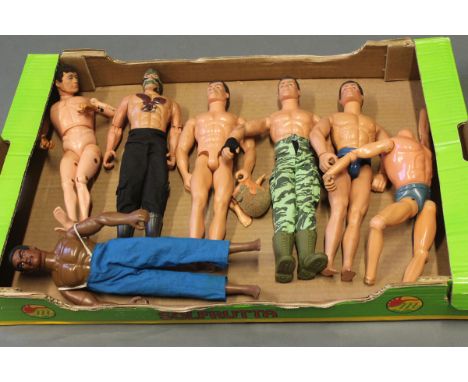 A box of vintage and modern Action Man dolls