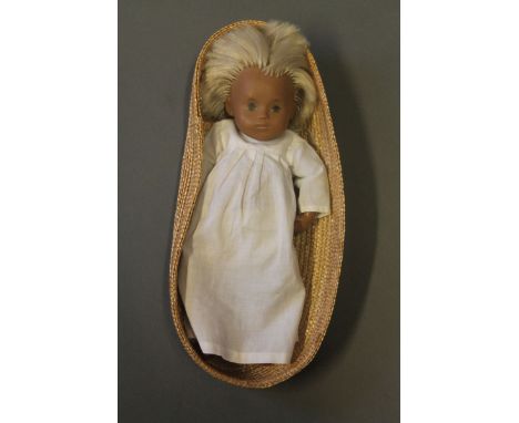 A vintage sasha doll in basket