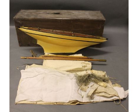 A cased vintage painted wooden & metal pond yacht with sails & written construction paperwork, 23ins in length x 8ins in heig