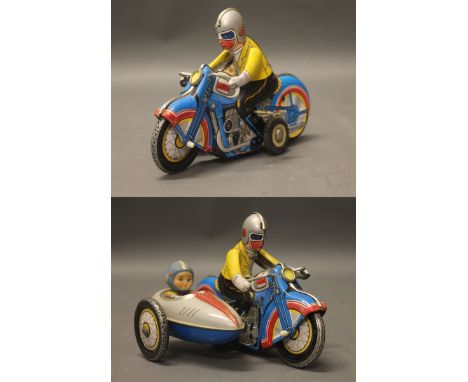 A vintage clockwork tinplate motorbike & side car