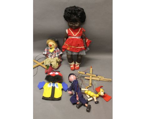 A vintage black baby doll together with a hand puppet & 3 vintage wooden string puppets (including Pelham)