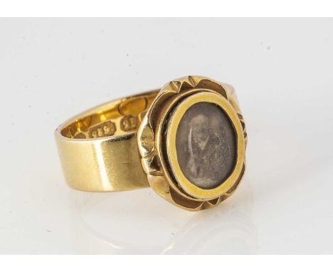 A Victorian 15ct gold locket ring, the oval top within a crimped frame on a wide band, hallmarked Birmingham 1868, ring size 