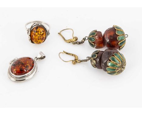 A pair of amber and enamel drop earrings, 5.5cm together with an amber silver locket, 3.2cm and a silver amber dress ring, ri