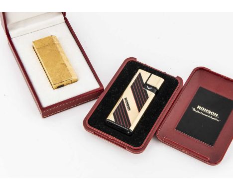 A Cartier gold plated lighter, of rectangular design with chamfered edge and having a textured satin finish, marked Cartier 2
