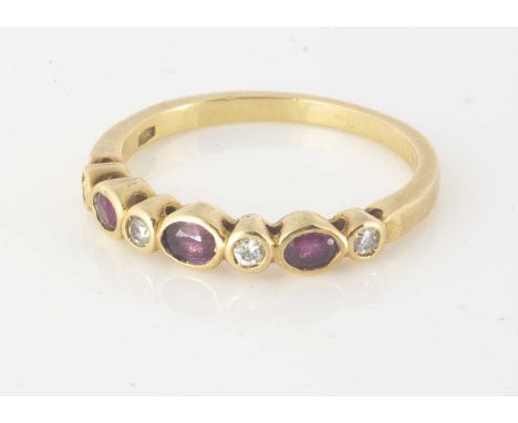 A ruby and diamond seven stone half hoop dress ring, in 18ct yellow gold, the round brilliant cut diamonds alternately set wi