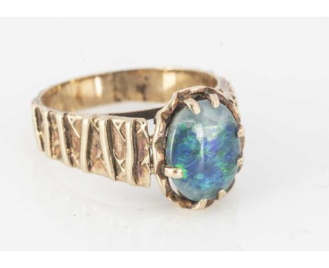 A 9ct gold and opal doublet dress ring, with textured flank with opal doublet top, ring size O, 4g